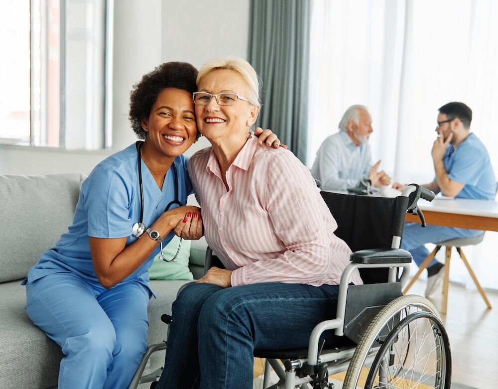 Senior woman in wheelchair with a nurse receiving skilled nursing care