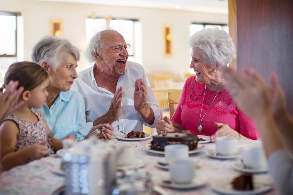 Group of seniors having fun with family at their senior living san dimas